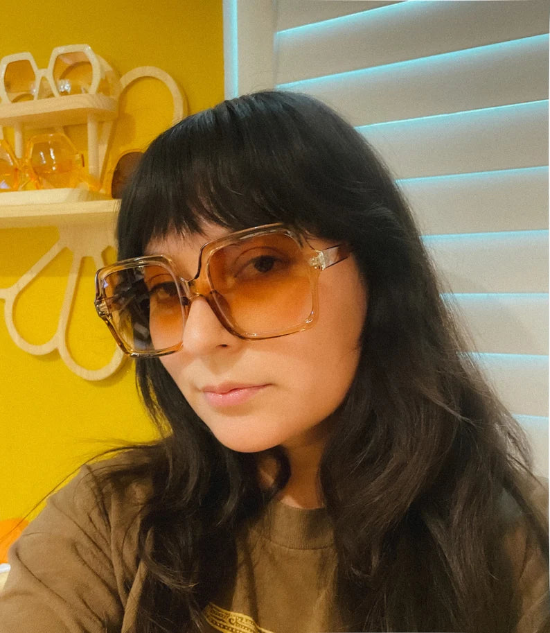 Women wearing 1970s Vintage DISCO Style Square Oversized Translucent Sunglasses on a yellow background